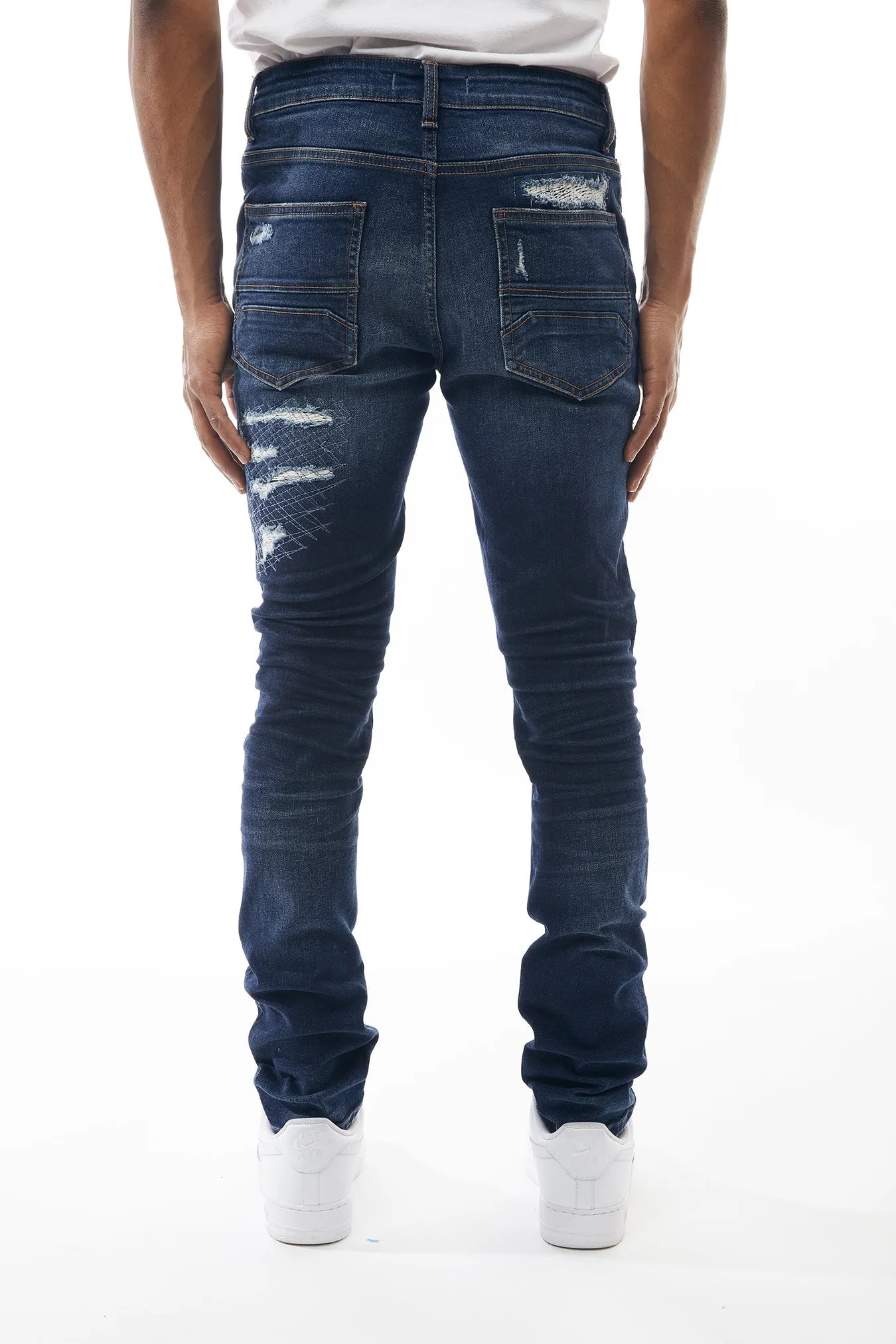 Ripped and Repaired Denim Jeans in Dusty