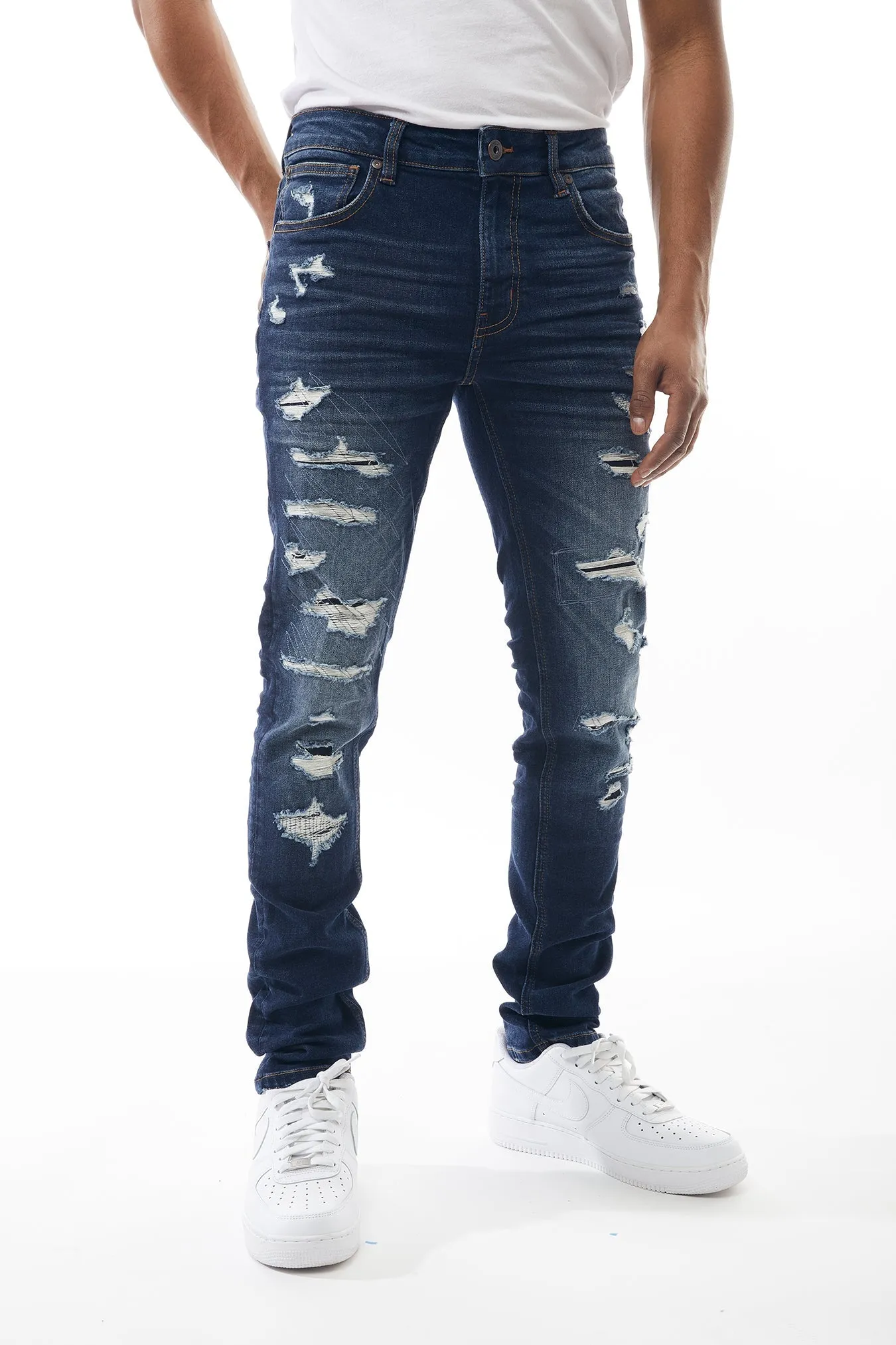 Ripped and Repaired Denim Jeans in Dusty