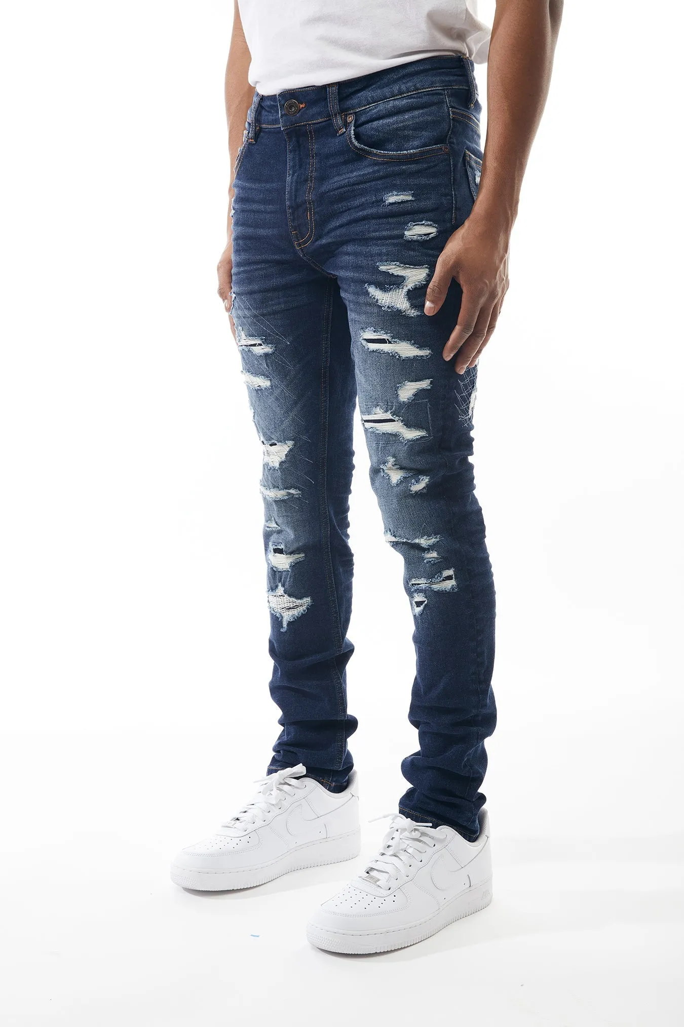Ripped and Repaired Denim Jeans in Dusty